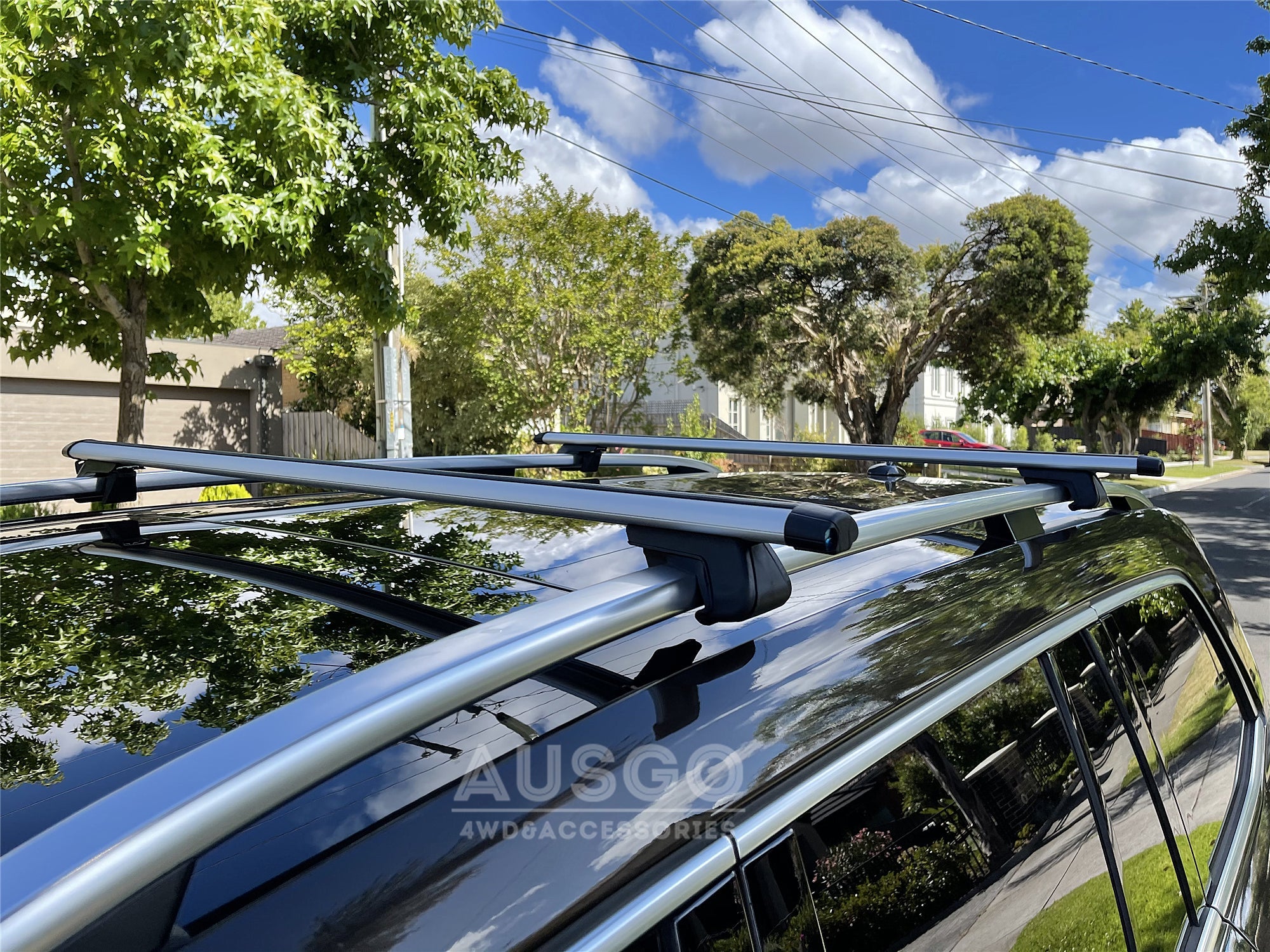Top view of a black Ford Explorer with cross bars installed on the car.