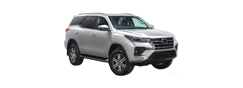 A white Toyota Fortuner parked in an outdoor carpark.