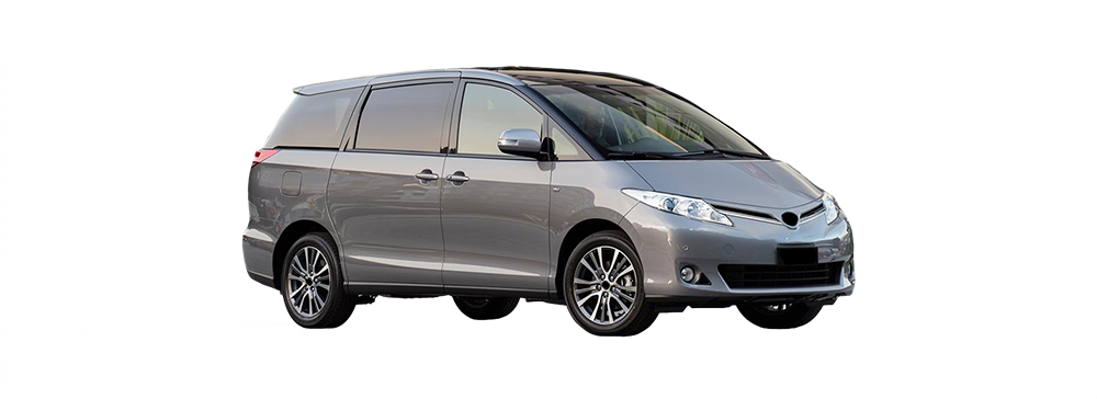 Side view of a white Toyota Tarago parked in an outdoor carpark.