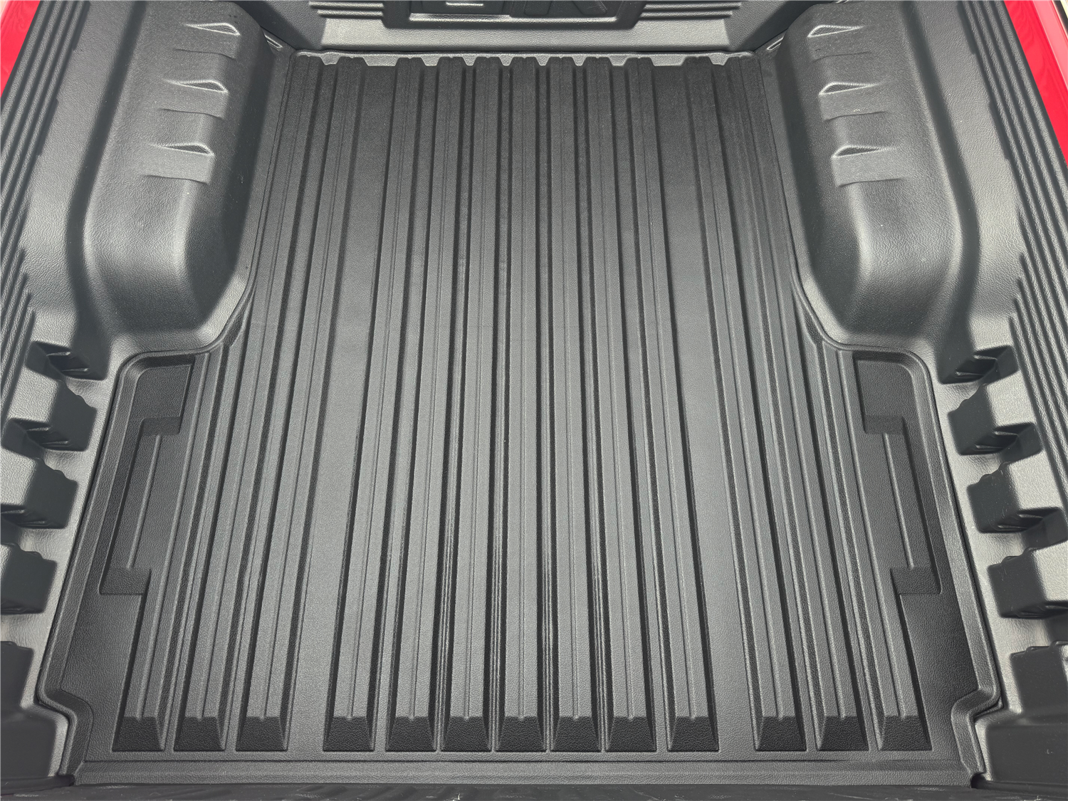 A black-coloured ute mat fit into a Toyota Hilux