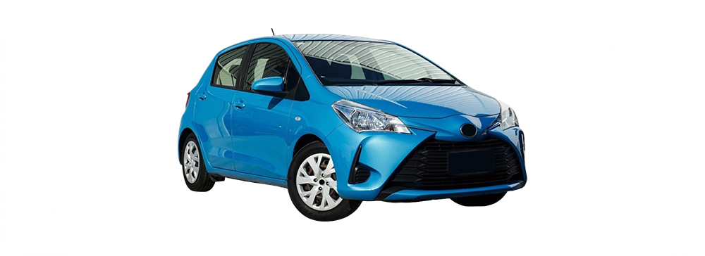 Side view of a white Toyota Yaris parked in an outdoor car park.