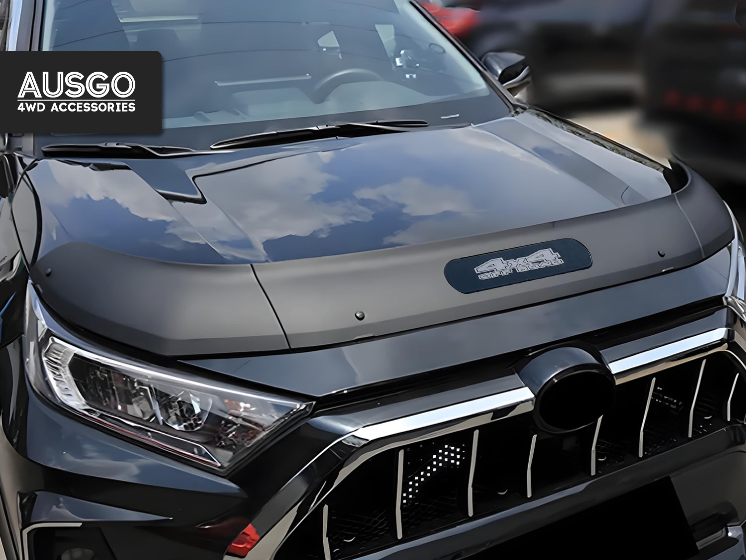 A black Toyota RAV4 with a glossy hood deflector featuring the "AUSGO Auto Accessories" logo.
