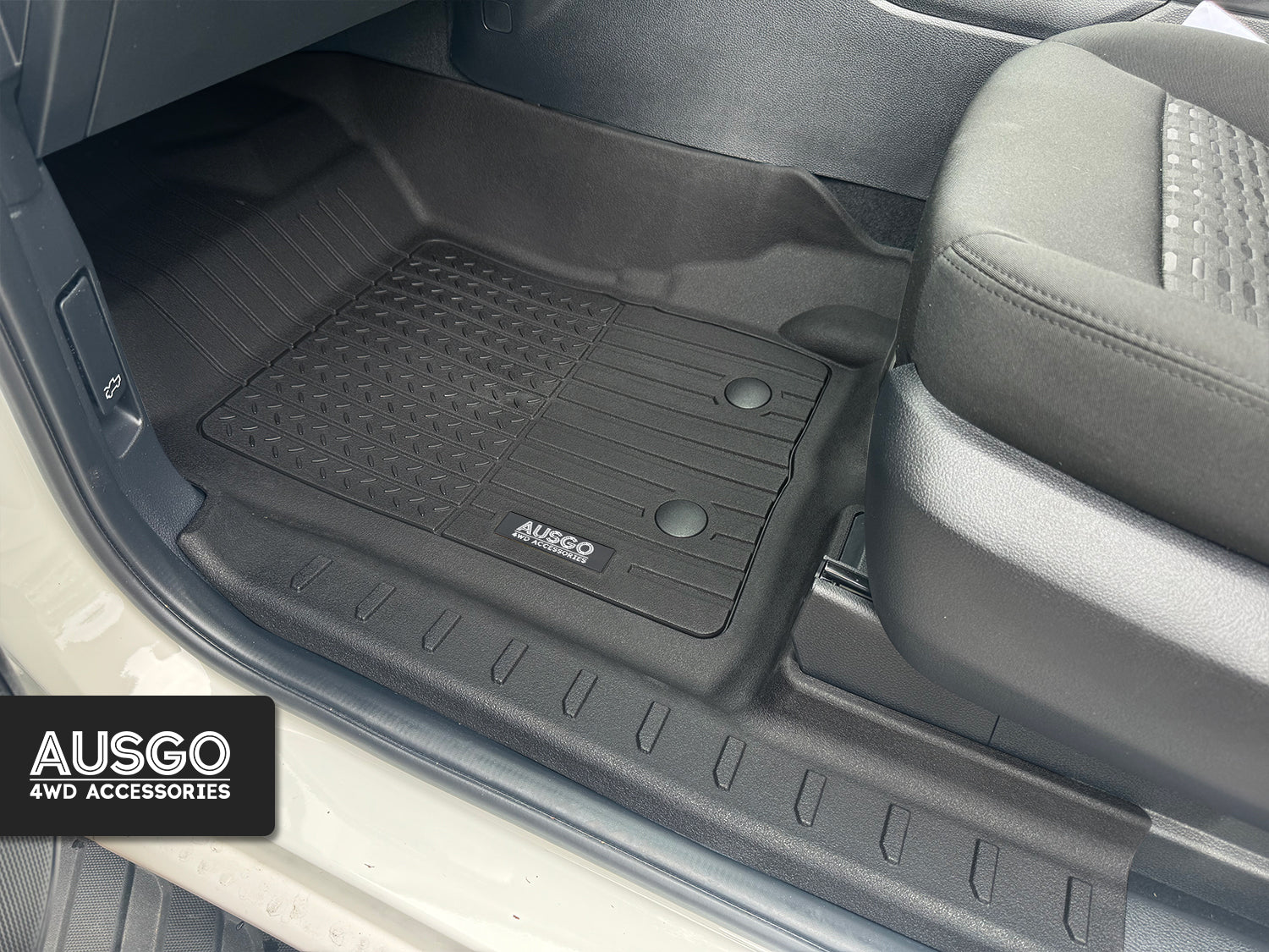 A zoomed in photo of a black floor mat installed in a Ford Everest. 