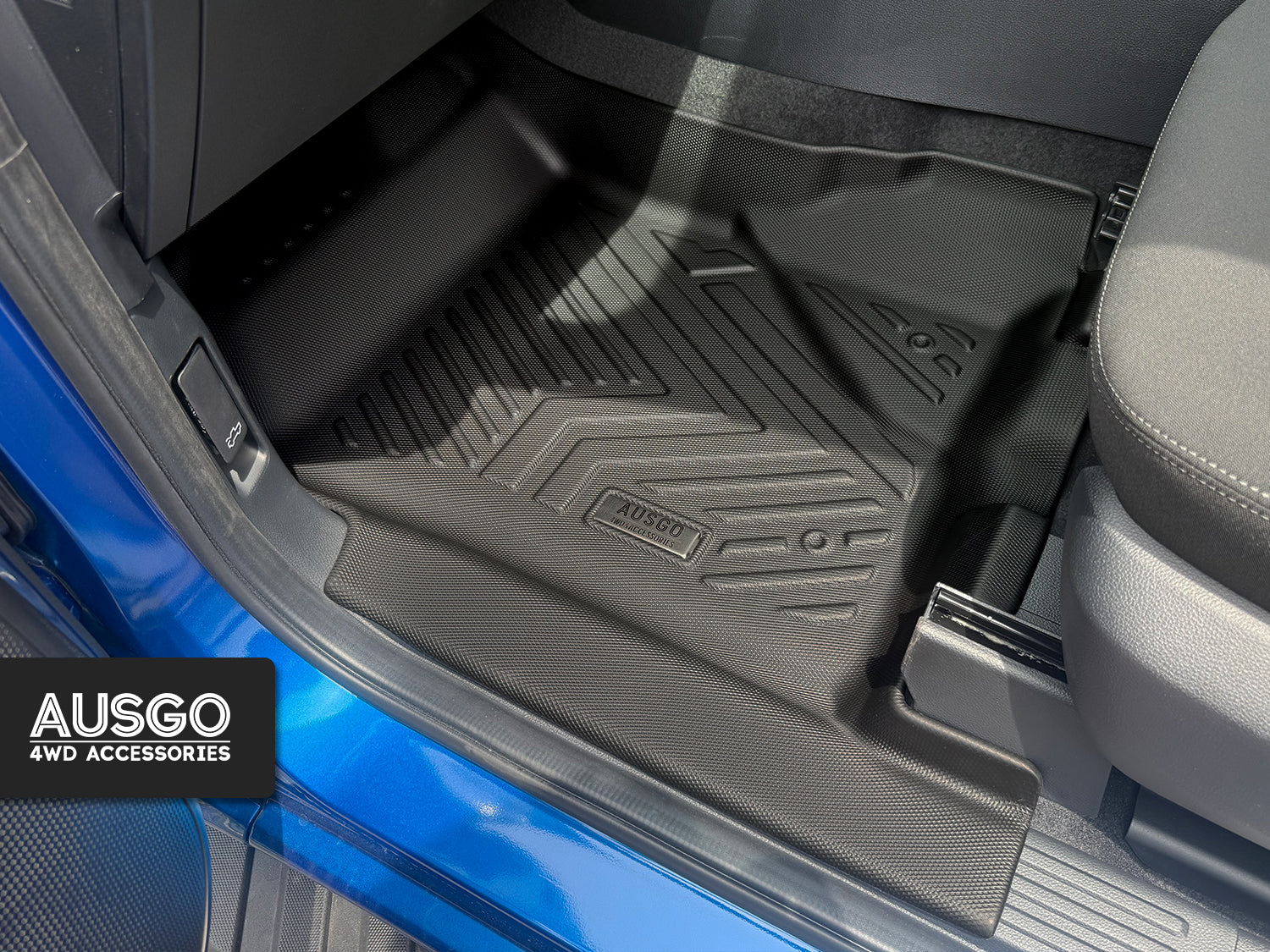 A black floor mat installed in the passenger seat of a Ford Ranger
